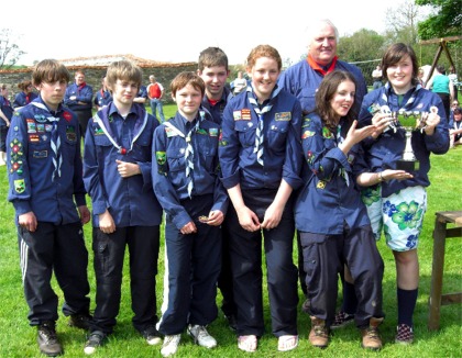 Muff scouts celebrate with their new trophy.