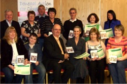 Cancer patients who modelled for charity receiving their DVDs of the extravaganza.