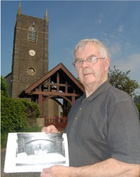 Vestry member Roy Mooney shows a picture of some of the items stolen in the raid.