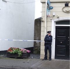 A Garda officer keeps watch at the scene of the alleged sexual assault in Buncrana.