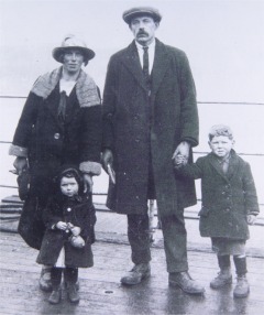 An historic photo of a family poignantly awaiting the emigration boat at Moville Pier.