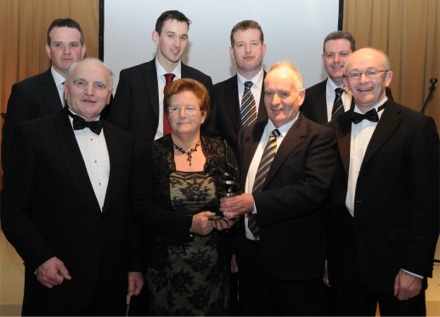 Moville's Pat McLaughlin and wife Margaret receive the 'Outstanding Contribution to the Local Economy Award' for 2009 from Michael McLoone, chairman, Donegal County Enterprise Board and Michael Tunney, ceo, Donegal County Enterprise Board. Back, left to right, are sons, Charles, Stephen, Sean and Patrick Junior. Photo: Paul MacGinty.