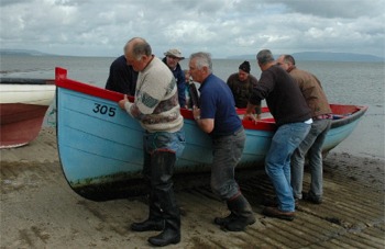 End of an era...Foyle drift netters haul their boats ashore. Photo courtesy BBC.